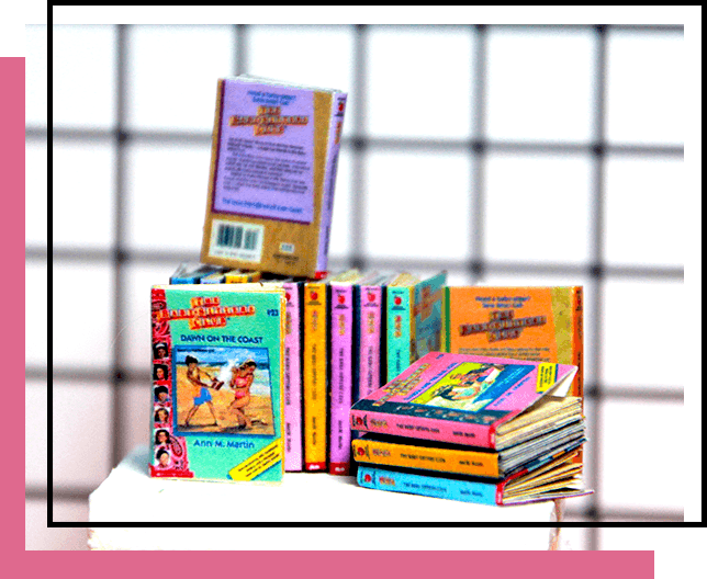 miniature The Babysitters Club books stacked on a white table